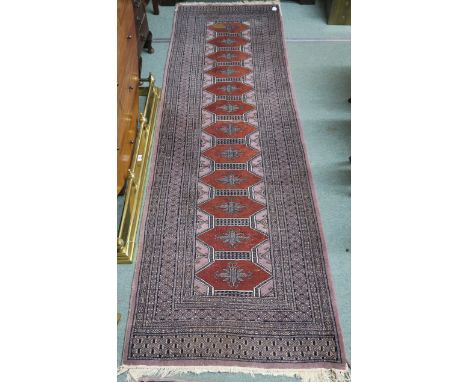 An Eastern runner with geometric design, 270cm x 80cm and a three panel Eastern rug, 150cm x 96cm (2) Condition Report: Avail