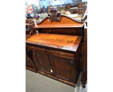 19th century flame mahogany veneered chiffonier with carved pediment over a single shelf and a base with single frieze drawer