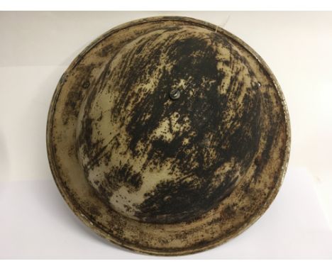 A WW2 South African Brodie helmet and liner dated 1939. The holes at the rear were for a nape cloth to protect the neck from 