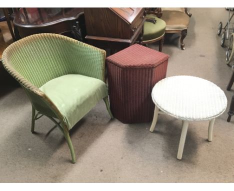 A collection of three Lloyd Loom items consisting of a green chair, a red lidded laundry basket and a white side table
