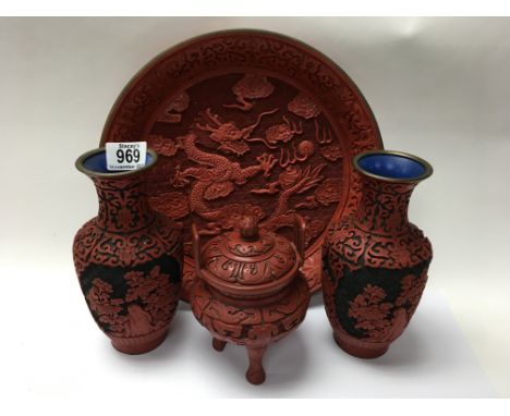 A Cinnibar ornately carved lacquer dragon and pearl charger, 30.5cm. Plus a pair of Carved Lacquer vases ( a/f) plus a later 