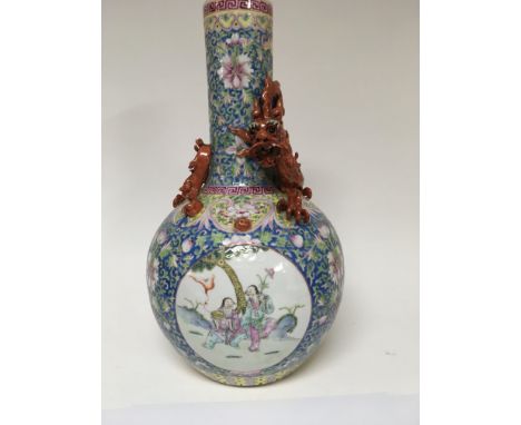 A 19 th century Chinese bottle vase the neck with an in twined dragon decorated with flowers and foliage on a light blue grou