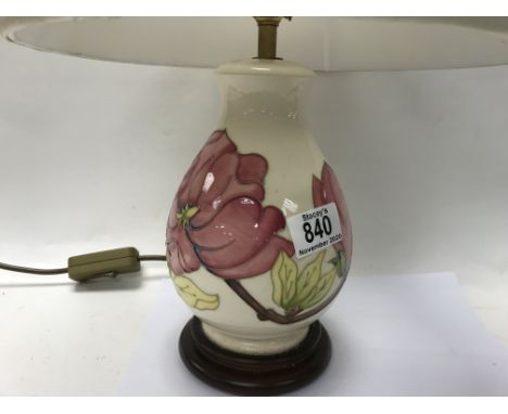 A Moorcroft pottery lamp, hibiscus pattern. 21.5cm plus shade.