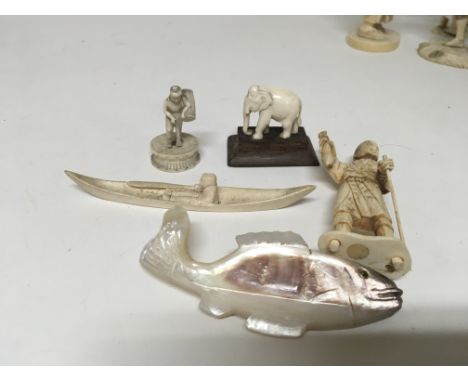 A collection of small carved ivory and bone figures and a mother of pearl carving in the form of a fish. (a lot) - NO RESERVE