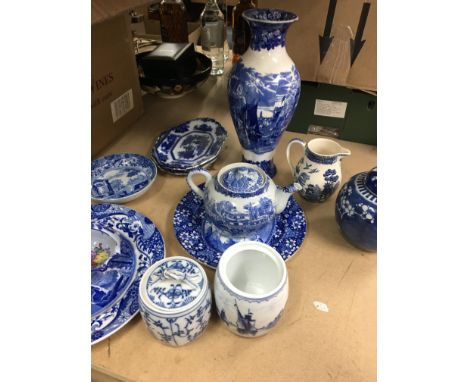 A collection of blue and white ceramics including a Wedgwood vase .