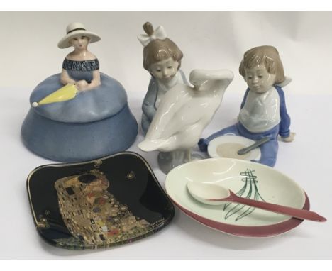 A Lladro swan, Two seated NAO figures of children, a Carlton ware dish and spoon, a Goebel glass dish and a 1930’s powder puf