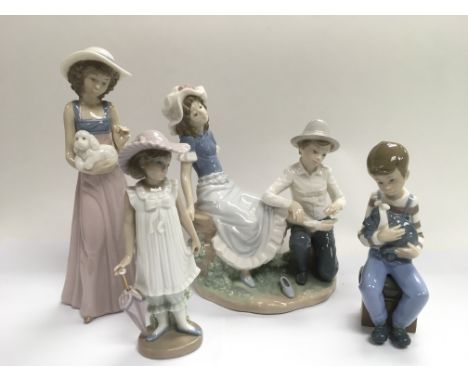 Four Nao figures of children.
