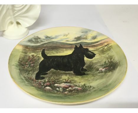 A Royal Worcester figure Joy and a vintage Royal Doulton plate decorated with a black Scottish terrier dog. (2)