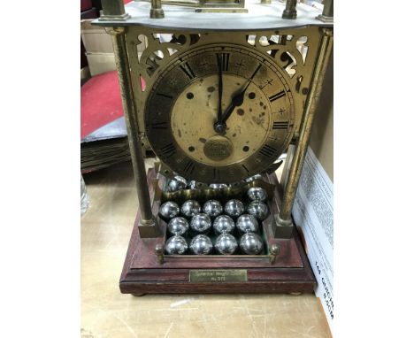A brass cased mystery spherical weight limited edition weight clock .