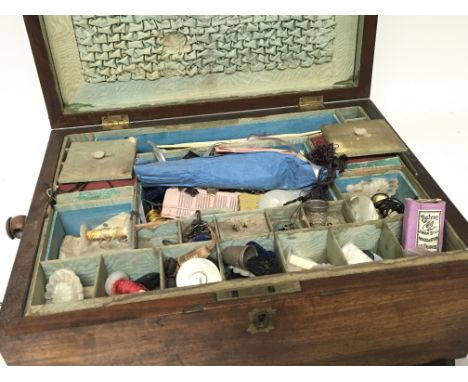 A Victorian mahogany sewing box containing bone and ivory crochet hooks mother of Pearl bobbins. carved parasol handles vinta