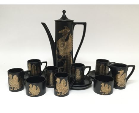 A Portmeirion Phoenix pattern black and gold coffee set, consisting of coffee pot, six cups and saucers, two sugar bowls and 