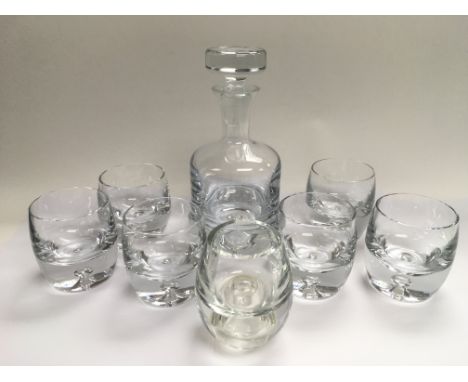 A modern cut glass decanter and glasses.