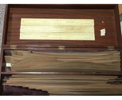 A boxed folding scaling instrument a box containing precession light wood templates. lacquer scientific tubes. In four fitted