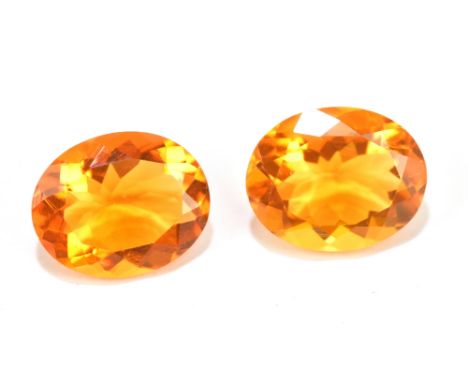 MEXICAN FIRE OPAL; a pair of 10mm x 8mm oval facet cut stones, weight 3.08ct (2).