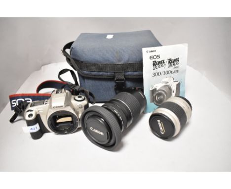 A Canon EOS300 camera body with EF 75-300mm 1;4-5,5 zoom lens and EF 28-90mm 1;4-5,6 lens in soft camera bag