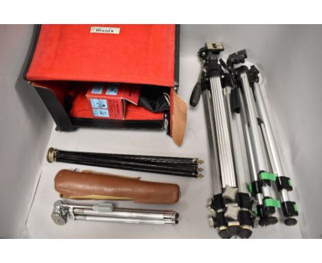 A Camera case with four tripods, connectors and filters etc