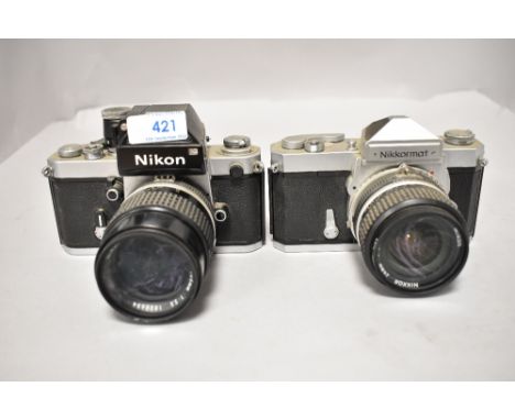 Two Nikon cameras a Nikkormat FT camera No FT3122842 with Nikkor 24mm 1;2,8 lens No 848590 and Nikon F2 camera NoF2 7801702 w