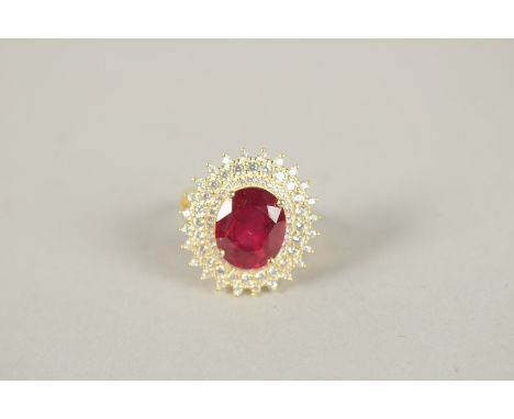 A SILVER GOLD PLATED RUBY CLUSTER RING.