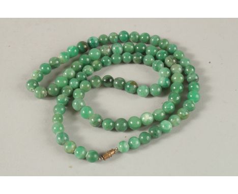 A GREEN JADE NECKLACE. 80cms long.