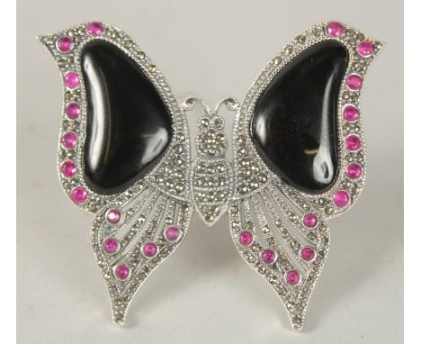 A SILVER ART DECO STYLE ONYX AND RUBY BUTTERFLY BROOCH.