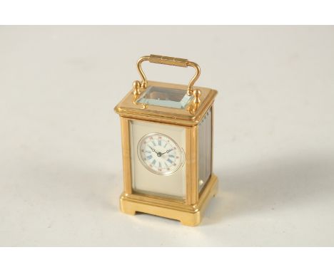 A PLAIN GILT MINI CARRIAGE CLOCK. 6cms high.