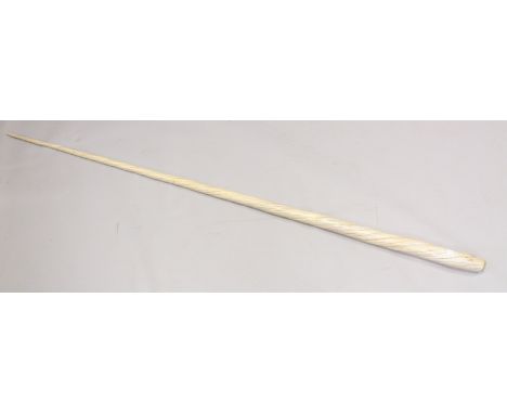 AN EARLY 19TH CENTURY NARWHAL TUSK 221cms long, weighing 4.6 kilos.Showing the expected age cracks over the length of the tus