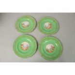 A SET OF FOUR ROYAL WORCESTER CIRCULAR GREEN PLATES the centres painted with a college and flowers