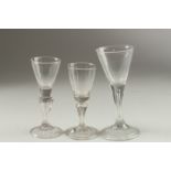 THREE CONICAL BASE WINE GLASSES. 16cm, 14cm & 13cm high.