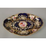 A ROYAL CROWN DERBY, OVAL BLUE GROUND DISH painted with flowers. 28cm long.