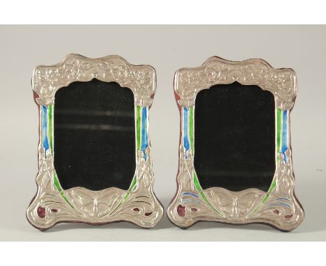 A PAIR OF SILVER AND ENAMEL ART DECO DESIGN PHOTOGRAPH FRAMES.