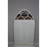 A WHITE METAL ARCHED MIRROR 124cm high, 61cm wide.