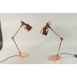 A SMALL PAIR OF COPPER ANGLE POISE LAMPS.