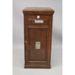 A VERY GOOD LARGE OAK COUNTRY HOUSE POST BOX, with brass plaques and letter slot, panelled door