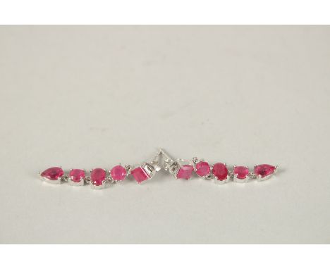 A PAIR OF SILVER FIVE STONE RUBY DROP EARRINGS.