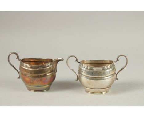 AN OVAL TWO HANDLED SUGAR BASIN AND MILK JUG. Birmingham 1916, weight: 12ozs.