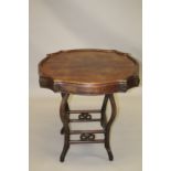 A CHINESE REDWOOD MAHJONG TABLE, 19TH CENTURY, the top of shaped circular outline, with four small