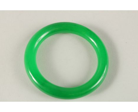 AN APPLE GREEN JADE BANGLE. 8cms diameter.