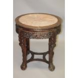A CHINESE CARVED HARDWOOD AND MARBLE TOP CIRCULAR URN STAND, 19TH CENTURY, with inset pink marble