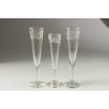 A PAIR OF FLUTE GLASSES engraved with fruiting vines. 22cm high and another with leaves, 20cm