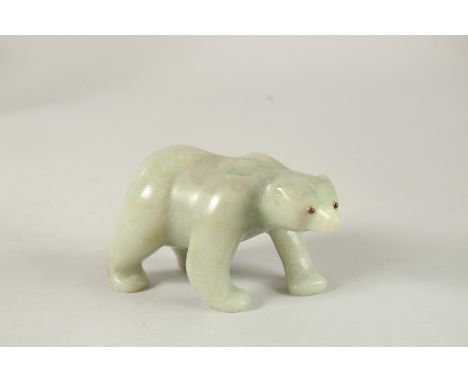 A LARGE RUSSIAN CARVED JADE POLAR BEAR with ruby eyes. 13cms long x 7cms high, in a Faberge box.