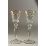 A GOOD LARGE PAIR OF ST. LOUIS GILDED TALL GLASSES. 25cm high.