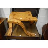 AN UNUSUAL ART DECO STYLE BURR WOOD COFFEE TABLE with curving legs.
