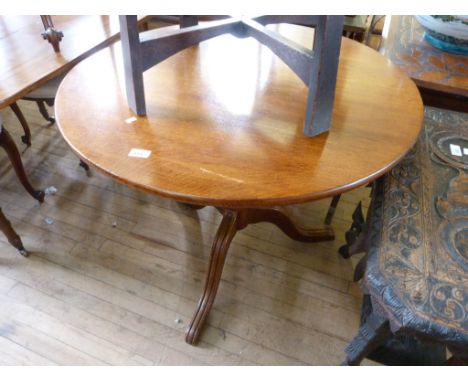 A Georgian light oak tilt top tripod table