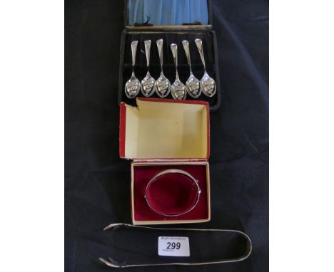 A cased set of silver teaspoons, together with a silver hinged bangle and white metal tongs. Approx. weight of hallmarked ite