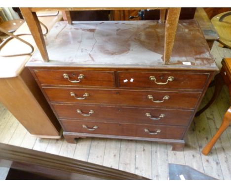 A Georgian mahogany straight front chest of two short over three long drawers, raised on bracket supports CONDITION REPORT: G