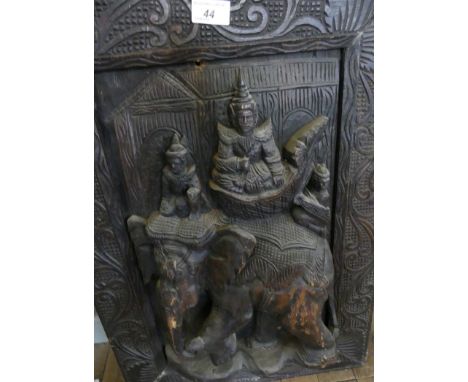 A Burmese carved hardwood panel decorated with figures on an elephant 