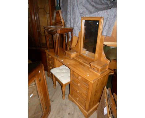 A reproduction light wood mirrored back dressing table, having an assortment of eight drawers