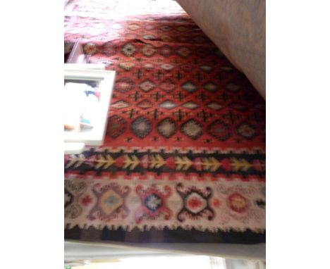 A early 20th Century Kelim floor rug, decorated with red central panel with geometric design, 265x205cm (af)