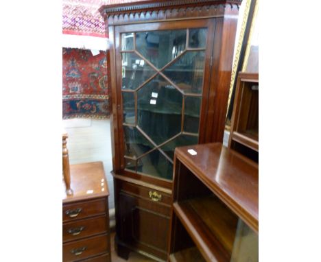 A George III mahogany floor standing corner cabinetFormed of two sections, the top section with dentil cornice and single ast