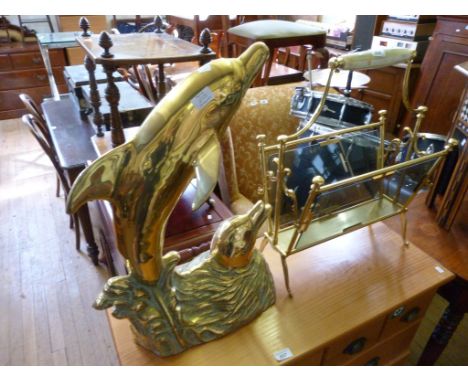 A modern brass model of two leaping dolphins, together with a brass framed magazine rack